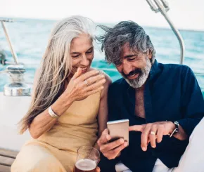 couple_on_a_yacht_laughing_at_phone