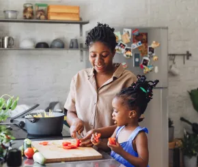 Mother and daughter cooking in the kitchen