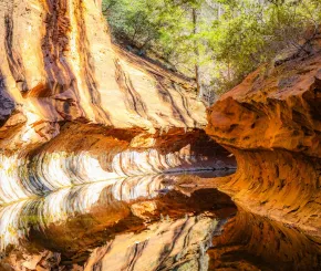 Large red rocks reflecting in water
