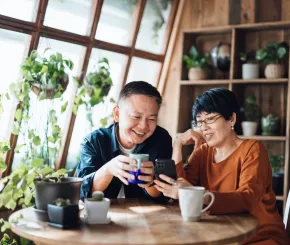 Older couple sitting at a table drinking tea