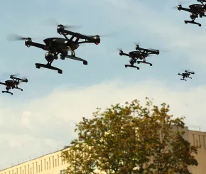 A picture of drones flying over a tree