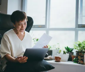 serious-senior-woman-checking-bills