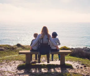Mother and children looking out at sea