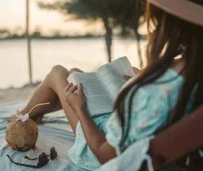 Woman reading on beach holiday