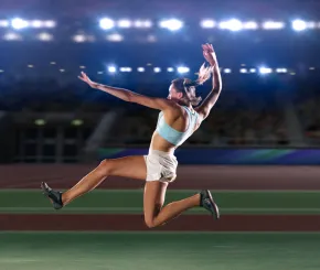 A female athlete landing from jumping