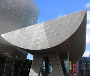 Sunlight bounces off the metallic architecture of the Lowry Arts Centre in Salford Quays of Greater Manchester