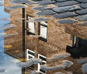 House reflected in puddle 