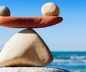 Balancing stones with waves in the background