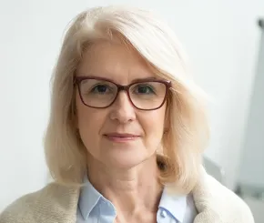 Woman with glasses looking straight ahead