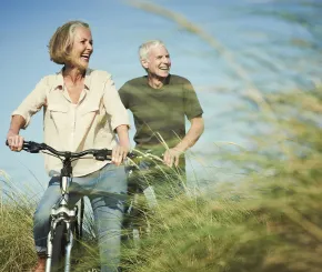 senior_couple_enjoying_day_out_on_their_bicyc.jpg