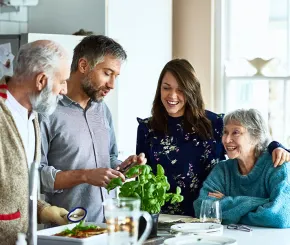 family group talking together in the kitchen space
