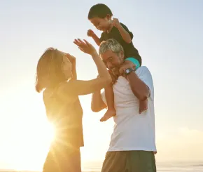 father_carrying_an_infant_on_his_shoulders_on