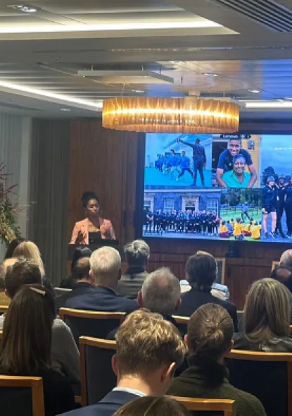 Audience members listen to a speaker