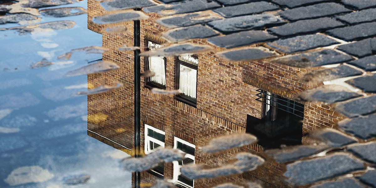 House reflected in puddle 