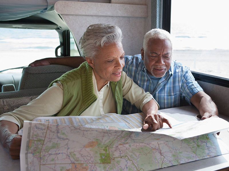 a couple planning their retirement adventure looking at a map