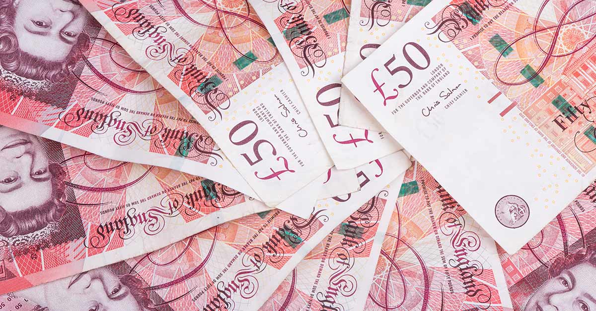 Fifty-pound sterling notes in a pile