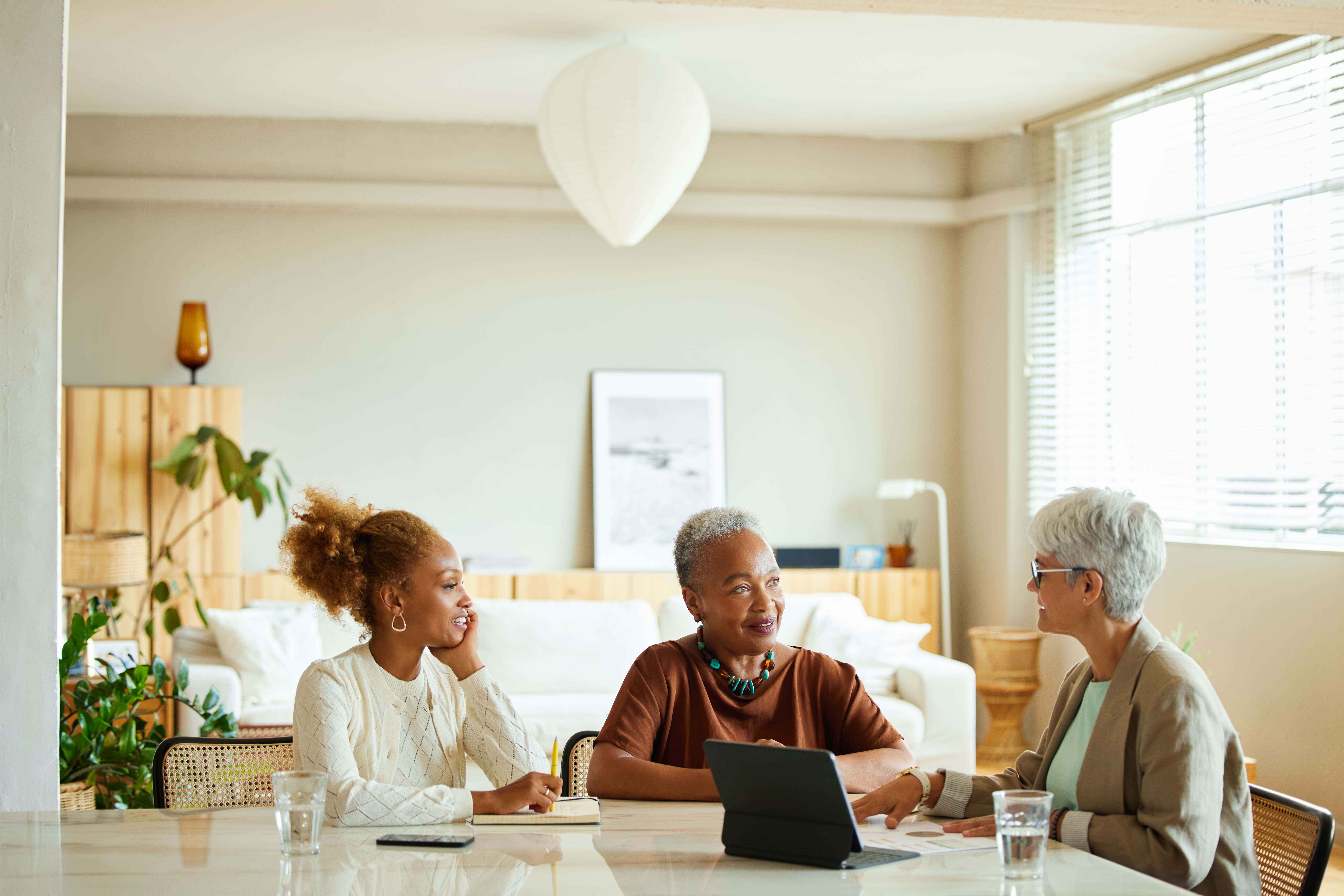Images of people talking sat around a table
