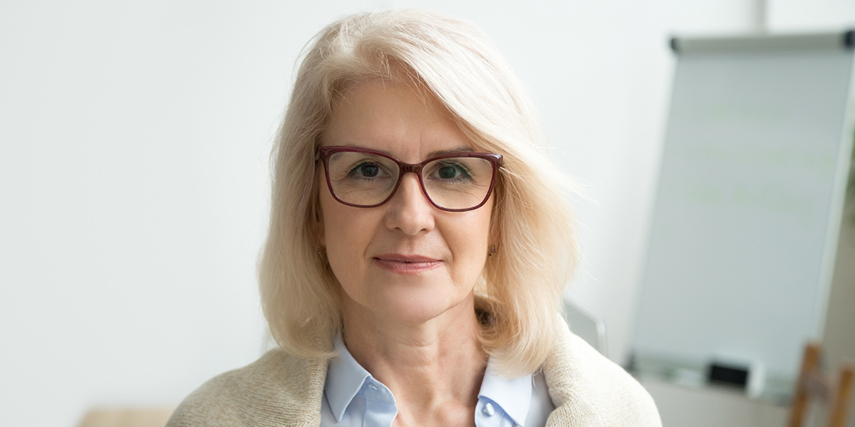 Woman with glasses looking straight ahead
