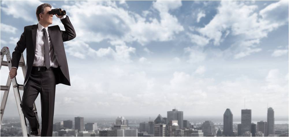The value of active investment - Rathbone Investment Management Man on ladder looking over city skyline - Rathbone Investment Management