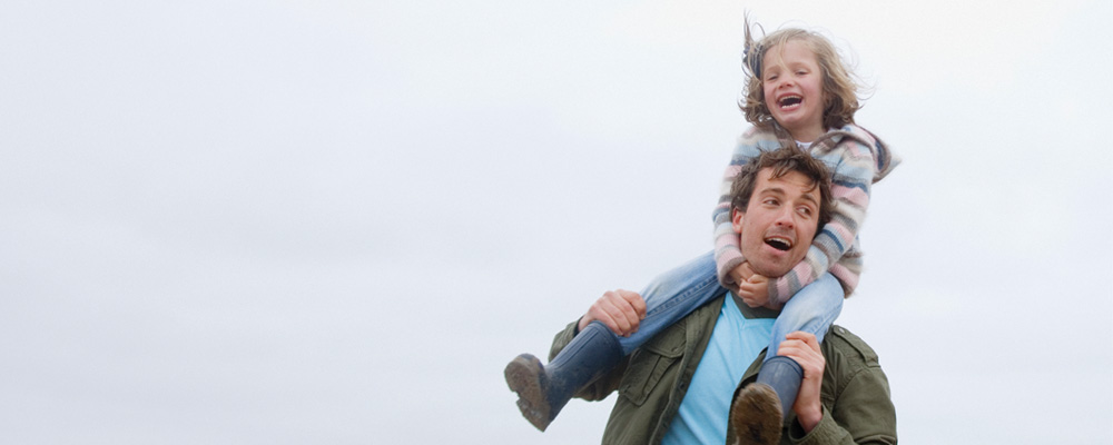 Heirs and graces - Rathbone Investment Management Young girl sat on her fathers shoulders - Rathbone Investment Management