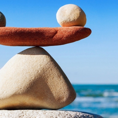 Balancing stones with waves in the background