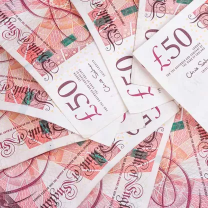 Fifty-pound sterling notes in a pile