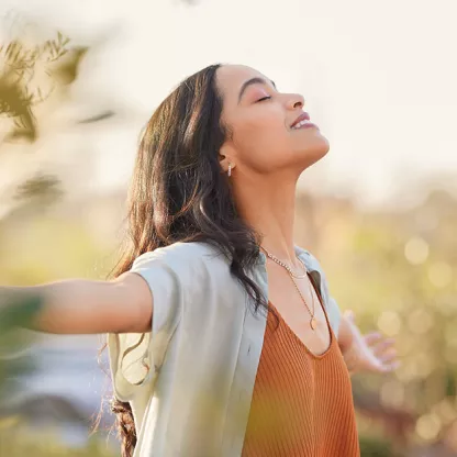 Woman in a field looking content